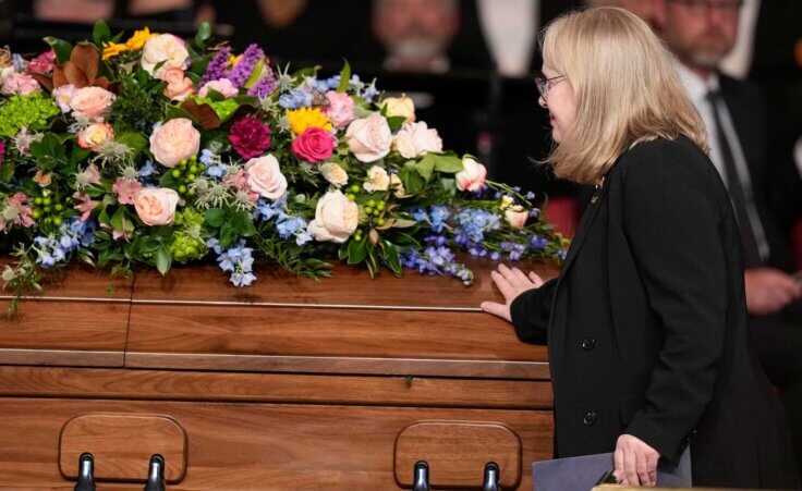 Amy Carter touches the casket after speaking at a tribute service for her mother, former first lady Rosalynn Carter, at Glenn Memorial Church at Emory University on Tuesday, Nov. 28, 2023, in Atlanta. (AP Photo/Brynn Anderson, Pool)