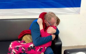 In this photo provided by the Israeli Army, Emily Hand, right, a released hostage, reunites with her father Sunday, Nov. 26, 2023, in Israel. (The Israeli Army via AP)
