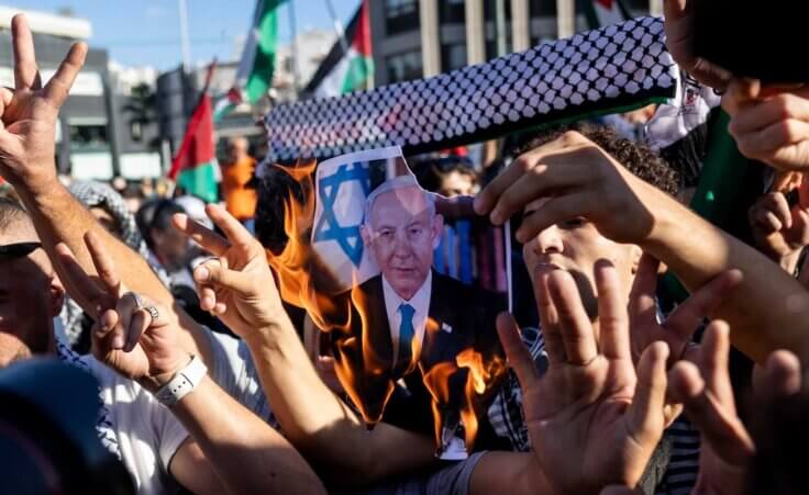 Pro-Palestinian protesters burn a photograph of Israeli Prime Minister Benjamin Netanyahu during a rally to express solidarity with Palestinians, in front of the Israeli embassy, in Athens, Greece, Sunday, Nov. 5, 2023. (AP Photo/Yorgos Karahalis). As antisemitism rises and Palestinians in Gaza suffer, we're led to a rational question: Why does God allow suffering?