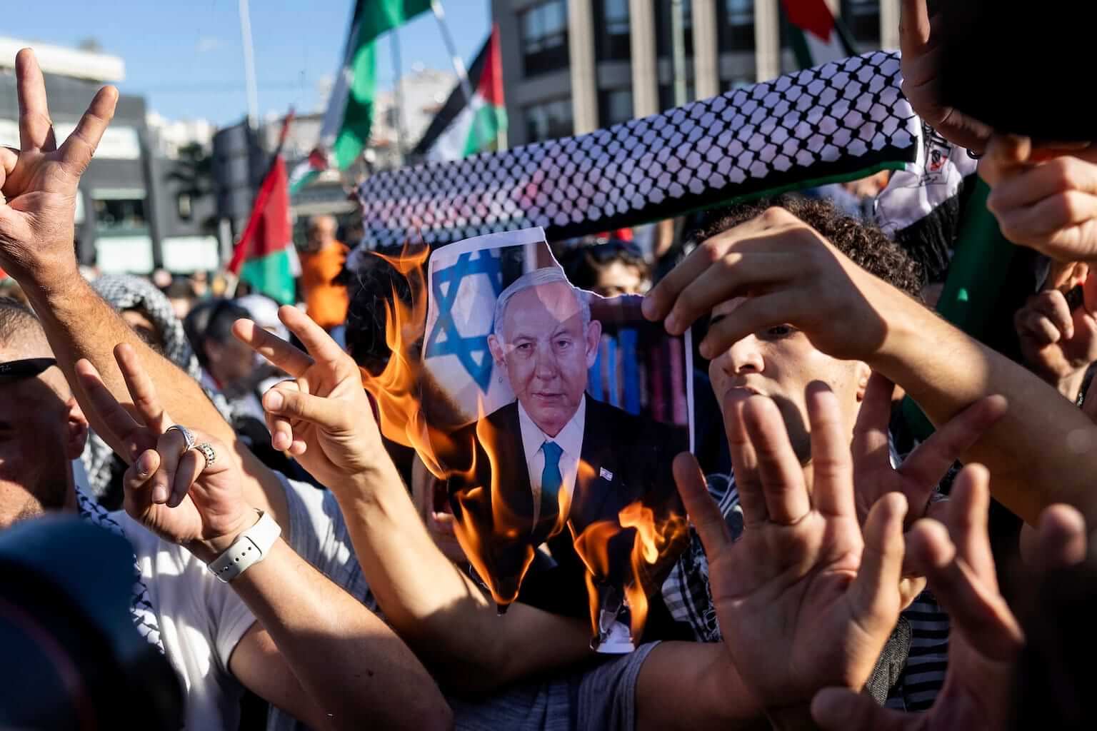 Pro-Palestinian protesters burn a photograph of Israeli Prime Minister Benjamin Netanyahu during a rally to express solidarity with Palestinians, in front of the Israeli embassy, in Athens, Greece, Sunday, Nov. 5, 2023. (AP Photo/Yorgos Karahalis). As antisemitism rises and Palestinians in Gaza suffer, we're led to a rational question: Why does God allow suffering?
