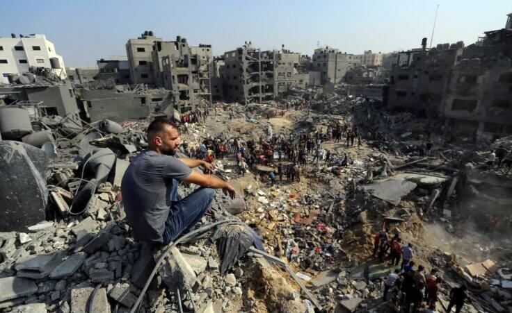 A man sits on the rubble overlooking the debris of buildings that were targeted by Israeli airstrikes in the Jabaliya refugee camp, northern Gaza Strip, Wednesday, Nov. 1, 2023. (AP Photo/Abed Khaled). As the death toll of Palestinian civilians climbs, many are calling for a ceasefire or a "humanitarian pause." But there's more to the story.