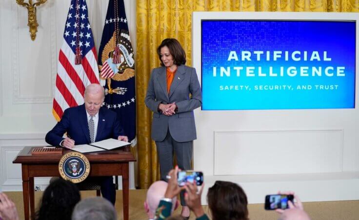 President Joe Biden signs an executive on artificial intelligence (AI) in the East Room of the White House, Monday, Oct. 30, 2023, in Washington. Vice President Kamala Harris looks on at right. (AP Photo/Evan Vucci)