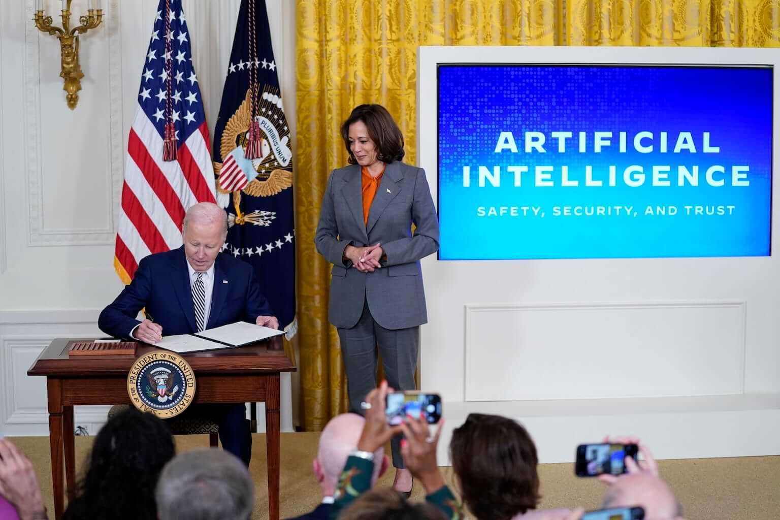 President Joe Biden signs an executive on artificial intelligence (AI) in the East Room of the White House, Monday, Oct. 30, 2023, in Washington. Vice President Kamala Harris looks on at right. (AP Photo/Evan Vucci)