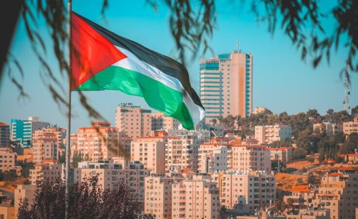 The Palestinian flag flies in front of the West Bank city of Ramallah. By nayefhammouri/stock.adobe.com. How was Palestine formed?