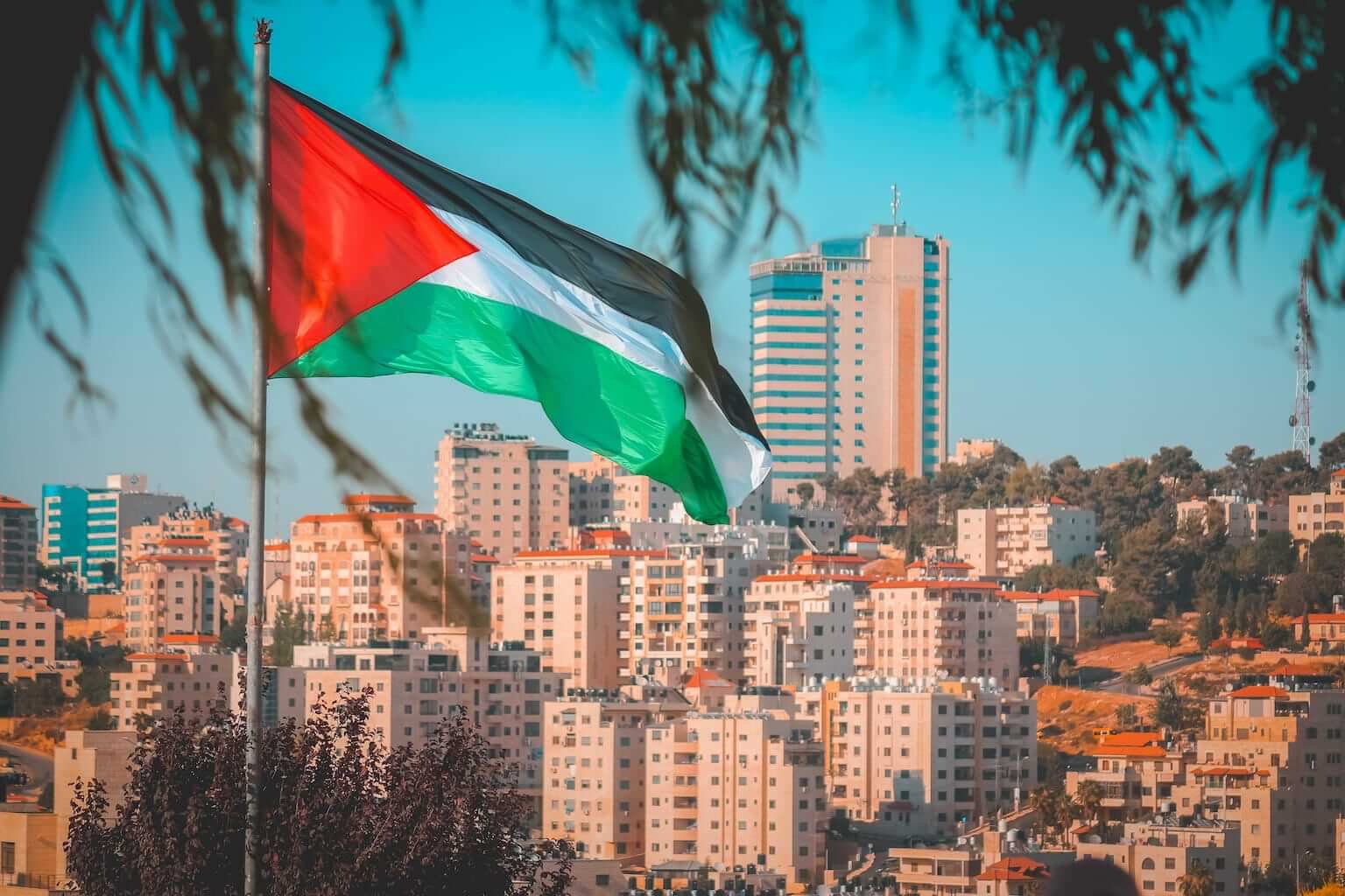The Palestinian flag flies in front of the West Bank city of Ramallah. By nayefhammouri/stock.adobe.com. How was Palestine formed?