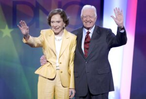 FILE - Former President Jimmy Carter, right, and his wife, former first lady Rosalynn Carter, wave to the audience at the Democratic National Convention in Denver, Aug. 25, 2008. Rosalynn Carter, the closest adviser to Jimmy Carter during his one term as U.S. president and their four decades thereafter as global humanitarians, died Sunday, Nov. 19, 2023. She was 96. (AP Photo/Ron Edmonds, File)