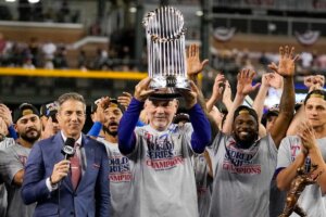 Texas Rangers manager Bruce Bochy holds up the trophy after Game 5 of the baseball World Series against the Arizona Diamondbacks Wednesday, Nov. 1, 2023, in Phoenix. The Rangers won 5-0 to win the series 4-1. (AP Photo/Brynn Anderson)