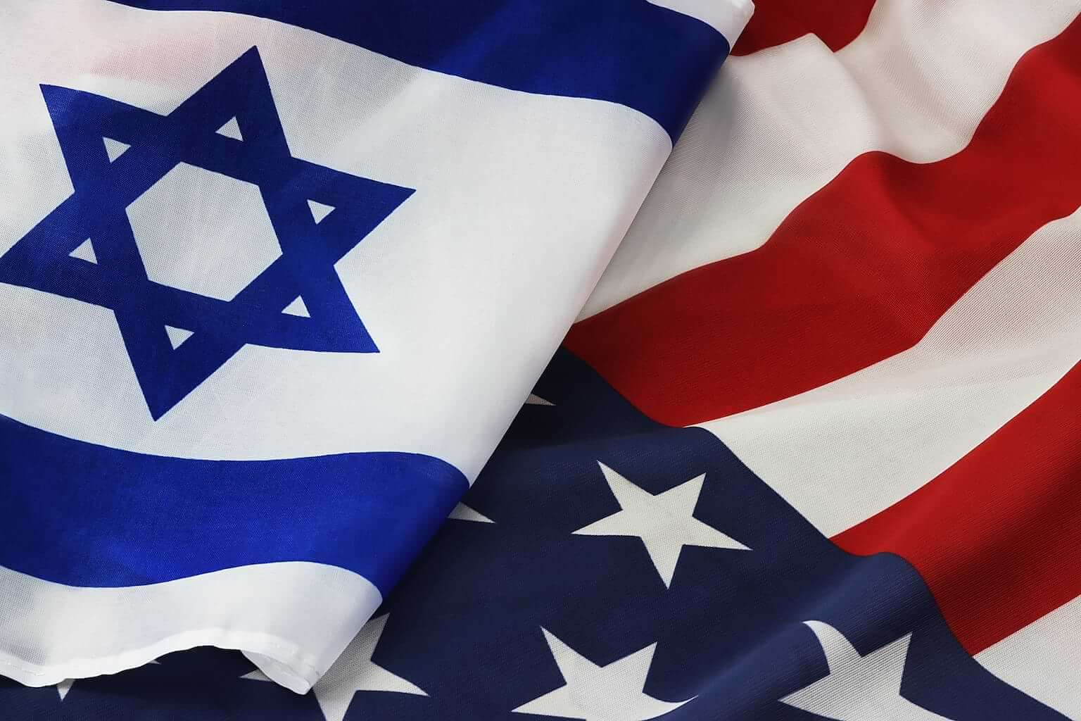 The flag of Israel sits atop the flag of the United States. By Shabtay/stock.adobe.com. This article states that America should support Israel.