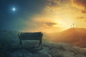 A manger at night sits in contrast to three crosses on a hill at daybreak signifying Christ's birth at Christmas, his death on the cross, and his ultimate resurrection. By Kevin Carden/stock.adobe.com