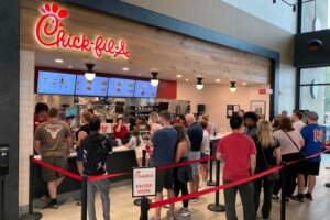 FILE -People line up to order fast food from a Chick-fil-A restaurant at the Iroquois Travel Plaza rest stop on the New York State Thruway in Little Falls, New York, on Friday, June 30, 2023. New York lawmakers have introduced a bill that would require restaurants in state highway system rest areas to operate seven days a week, a measure apparently aimed at interfering with a policy at the fast food chain Chick-fil-A of staying closed on Sundays. (AP Photo/Ted Shaffrey, File)