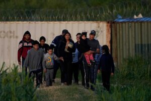 Migrants walk past a barrier after they crossed the Rio Grande and entered the U.S. from Mexico, Thursday, Oct. 19, 2023, in Eagle Pass, Texas. (AP Photo/Eric Gay) Such an immigration crisis is a complex issue.