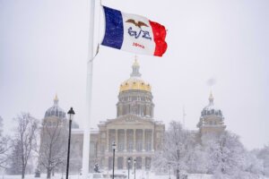 FILE - Snow falls at the Iowa State Capitol Building in Des Moines, Iowa, Jan. 9, 2024, as a winter snow storm hits the state. As frigid temperatures scour the Midwest, Monday, Jan. 15, marks the official start to the Republican presidential nominating contest with the Iowa caucus. (AP Photo/Andrew Harnik, File)