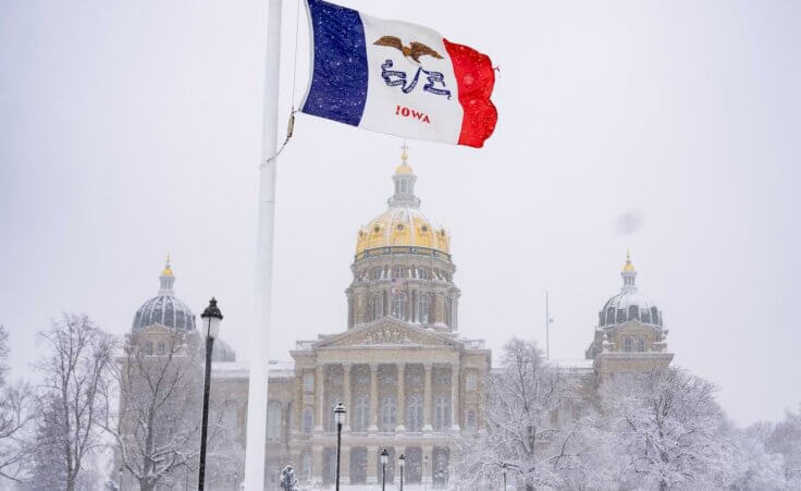 FILE - Snow falls at the Iowa State Capitol Building in Des Moines, Iowa, Jan. 9, 2024, as a winter snow storm hits the state. As frigid temperatures scour the Midwest, Monday, Jan. 15, marks the official start to the Republican presidential nominating contest with the Iowa caucus. (AP Photo/Andrew Harnik, File)