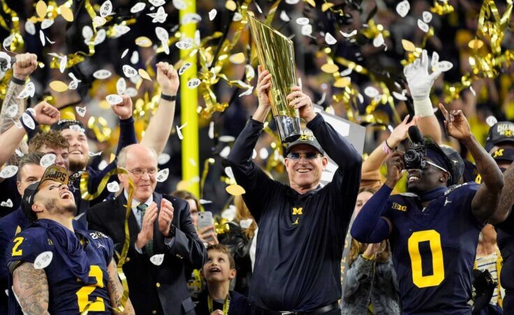 Michigan head coach Jim Harbaugh celebrates with the trophy after their win in the national championship NCAA College Football Playoff game against Washington Monday, Jan. 8, 2024, in Houston. (AP Photo/Eric Gay)