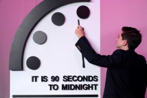 A staffer shows the location of the minute hand shortly before the Bulletin of the Atomic Scientists announces the latest decision on the Doomsday Clock minute hand, Tuesday, Jan. 23, 2024, at the National Press Club Broadcast Center, in Washington. This year, Jan. 2024, the clock will remain set to 90 seconds to midnight. (AP Photo/Jacquelyn Martin)