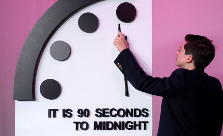 A staffer shows the location of the minute hand shortly before the Bulletin of the Atomic Scientists announces the latest decision on the Doomsday Clock minute hand, Tuesday, Jan. 23, 2024, at the National Press Club Broadcast Center, in Washington. This year, Jan. 2024, the clock will remain set to 90 seconds to midnight. (AP Photo/Jacquelyn Martin)