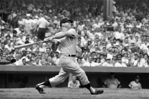 New York Yankees center fielder Mickey Mantle completes his swing as he hits his 49th home run of the season in the first inning against the Detroit Tigers at Yankee Stadium, Bronx, New York, September 3, 1961. The home run came with Mickey's teammate and home run rival Roger Maris, on base. ( AP Photo )