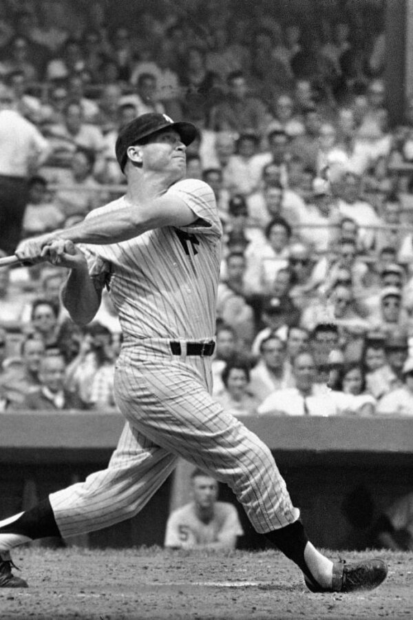 New York Yankees center fielder Mickey Mantle completes his swing as he hits his 49th home run of the season in the first inning against the Detroit Tigers at Yankee Stadium, Bronx, New York, September 3, 1961. The home run came with Mickey's teammate and home run rival Roger Maris, on base. ( AP Photo )
