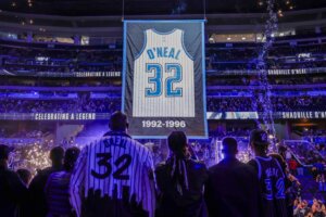 Shaquille O'Neal is joined by his family as they watch his jersey being raised as the Orlando Magic retire his jersey number after the team's NBA basketball game against the Oklahoma City Thunder, Tuesday, Feb. 13, 2024, in Orlando, Fla. (AP Photo/Kevin Kolczynski)
