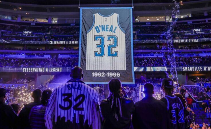 Shaquille O'Neal is joined by his family as they watch his jersey being raised as the Orlando Magic retire his jersey number after the team's NBA basketball game against the Oklahoma City Thunder, Tuesday, Feb. 13, 2024, in Orlando, Fla. (AP Photo/Kevin Kolczynski)