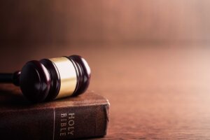A gavel rests on top of a closed Bible. By Jiri Hera/stock.adobe.com