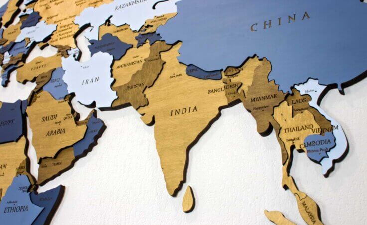 The country of India is centered on a wooden map. Religious persecution in India is rising. By Александра Замулина/stock.adobe.com