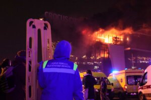 A medic stands near ambulances parked outside the burning building of the Crocus City Hall on the western edge of Moscow, Russia, Friday, March 22, 2024. (AP Photo/Vitaly Smolnikov)