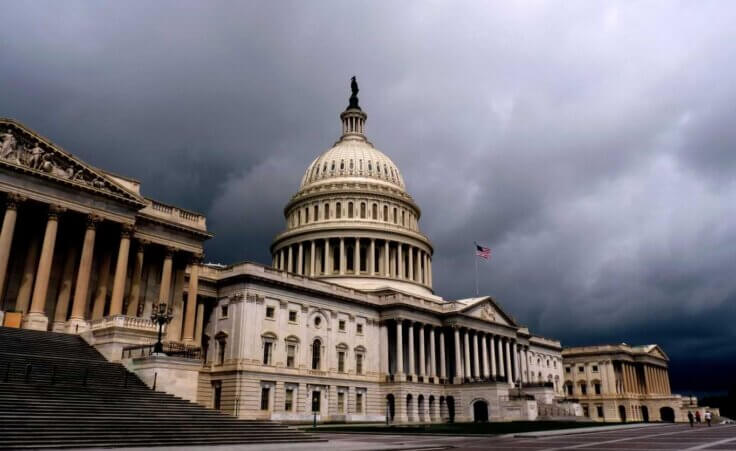 A dark, cloudy sky looms over the US Capitol building. By gelangelan/stock.adobe.com | politics in church
