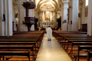 Priest in an empty church. Religious attendance By GodongPhoto/stock.adobe.com