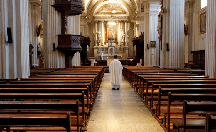 Priest in an empty church. Religious attendance By GodongPhoto/stock.adobe.com