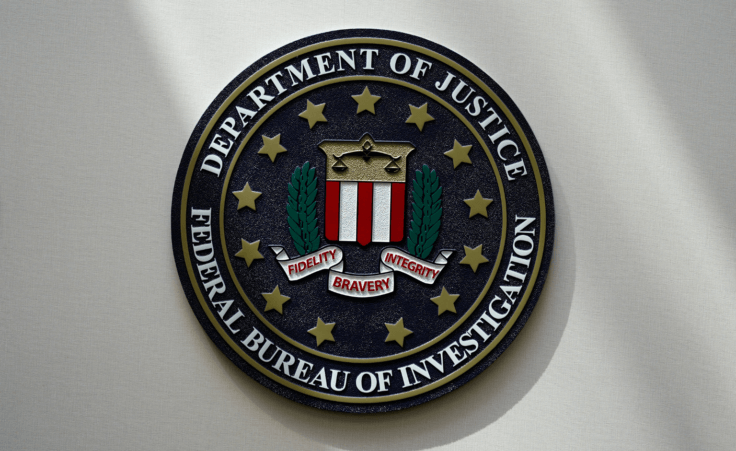 An FBI seal is seen on a wall in Omaha, Neb. An Idaho teenager is charged with attempting to provide material support to the terrorist group ISIS after prosecutors said he planned to carry out an attack on a Coeur d'Alene church. (AP Photo/Charlie Neibergall, File)
