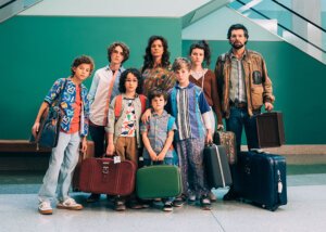 A still photo from the film "Unsung Hero" showing the Smallbone family carrying suitcases in an airport. Photo provided by Troops & Allies.