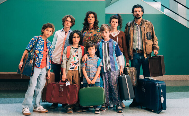 A still photo from the film "Unsung Hero" showing the Smallbone family carrying suitcases in an airport. Photo provided by Troops & Allies.