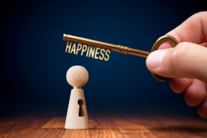 Key labeled "happiness" next to a figurine with a keyhole. By jirsak/stock.adobe.com How to buy happiness with time
