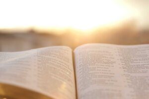 A Bible lays open in front of a sunrise. By Sergio Yoneda/stock.adobe.com