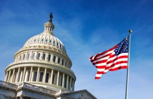 The American flag flies next to and in front of Capitol Hill. By rarrarorro/stock.adobe.com