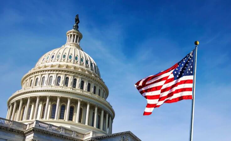 The American flag flies next to and in front of Capitol Hill. By rarrarorro/stock.adobe.com