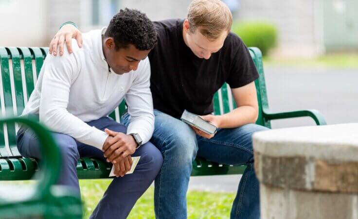 Two men praying together. By Lydia/stock.adobe.com