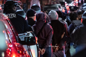 New York City police officers take people into custody near the Columbia University campus in New York Tuesday, April 30, 2024, after a building taken over by protesters earlier in the day was cleared, along with a tent encampment. (AP Photo/Craig Ruttle)