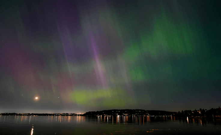 The northern lights, or aurora borealis, are visible over Lake Washington, in Renton, Wash., on Friday evening over Ascension Sunday weekend. (AP Photo/Lindsey Wasson)