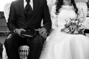 Bride and a groom holding hands during marriage ceremony. By Vlad Negru/Wirestock/Stock.Adobe.com