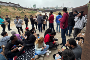 Migrants seeking asylum rest as they wait to be processed after crossing the border Wednesday, June 5, 2024, in San Diego, Calif. President Joe Biden has unveiled plans to enact immediate significant restrictions on migrants seeking asylum at the U.S.-Mexico border as the White House tries to neutralize immigration as a political liability ahead of the November elections. (AP Photo/Eugene Garcia)