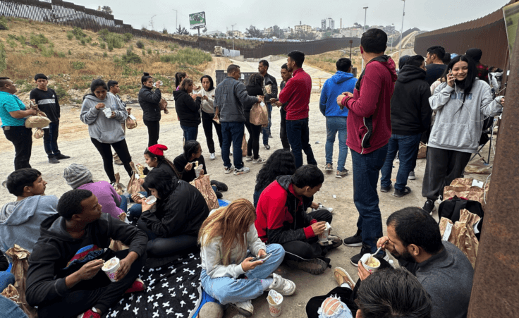 Migrants seeking asylum rest as they wait to be processed after crossing the border Wednesday, June 5, 2024, in San Diego, Calif. President Joe Biden has unveiled plans to enact immediate significant restrictions on migrants seeking asylum at the U.S.-Mexico border as the White House tries to neutralize immigration as a political liability ahead of the November elections. (AP Photo/Eugene Garcia)