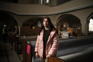 Alone Fartukhova, a student from Ukraine poses for a photo after a church service and prayer for peace in an evangelical church in Berlin, Sunday, March 20, 2022. (AP Photo/Steffi Loos) Russia