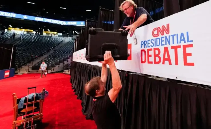 Bob Reilly, crew chief, and cameraman Chris Hanson, above, both of CSpan, setup for the upcoming CNN Presidential Debate between President Joe Biden and Republican presidential candidate former President Donald Trump in Atlanta, Wednesday, June 26, 2024. (AP Photo/Gerald Herbert)
