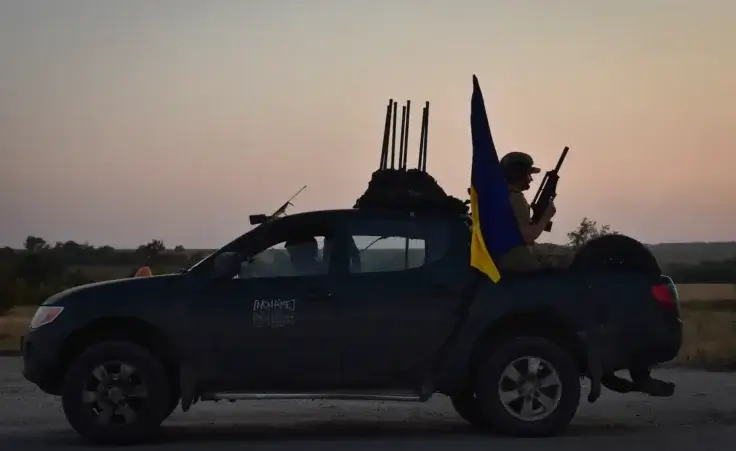 A soldier of Ukraine's 141st separate infantry brigade rides in a pickup truck at the frontline in Zaporizhzhia region, Ukraine, Monday, Aug. 19, 2024. (AP Photo/Andriy Andriyenko)