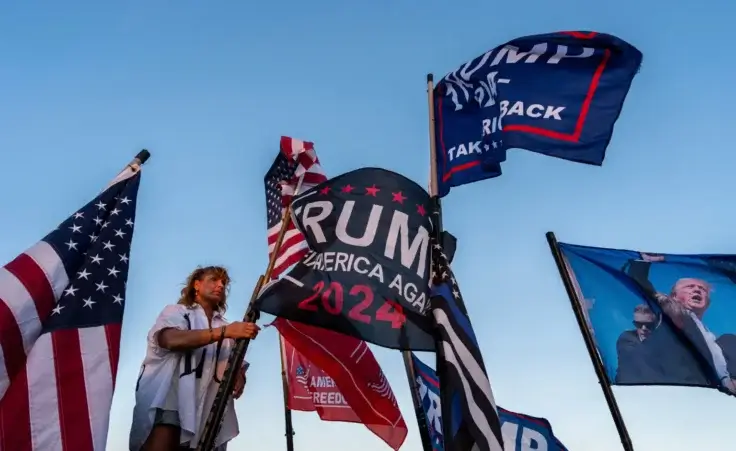 Nikki Fuller, 56, sets up flags on her truck near the Mar-a-Lago estate of President-elect Donald Trump, Monday, Nov. 11, 2024, in Palm Beach, Fla. (AP Photo/Julia Demaree Nikhinson) Fema trump sign