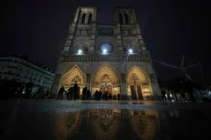 People arrive at Notre Dame Cathedral for the first public mass since the catastrophic fire of 2019, Sunday Dec. 8, 2024 in Paris. (AP Photo/Alessandra Tarantino)