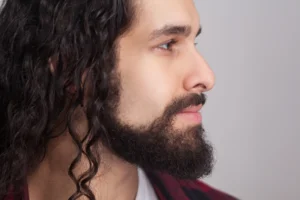 Side profile of man with long, curly hair and a short beard. By khosrork/stock.adobe.com. Jesus model, winter solstice