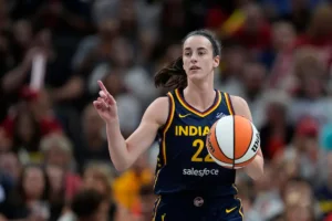 Indiana Fever's Caitlin Clark dribbles during the first half of a WNBA basketball game against the Seattle Storm, Sunday, Aug. 18, 2024, in Indianapolis. (AP Photo/Darron Cummings)